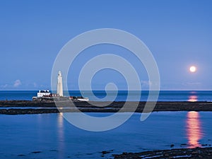 St Marys Lighthouse and Island at Whitley Bay, North Tyneside, UK with supermoon and reflections