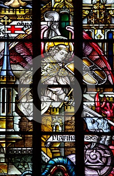 St. Michael (angel) fighting evil (stained glass)