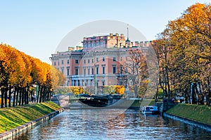 St. Michael`s Castle Mikhailovsky Castle or Engineers` Castle and Lebyazhya Kanavka canal in autumn, Saint Petersburg, Russia