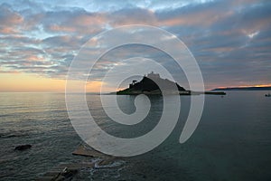 St Michael`s Mount Castle Walkway to Island, with sunset in Cornwall