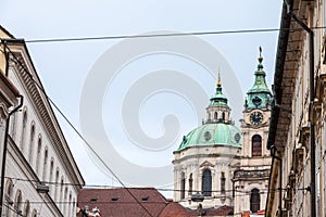 St Nicholas Church, also called Kostel Svateho Mikulase, in Prague, Czech Republic, with its iconic dome seen from nearby streets