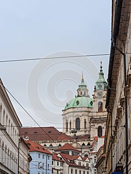 St Nicholas Church, also called Kostel Svateho Mikulase, in Prague, Czech Republic, with its iconic dome seen from nearby streets