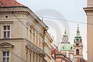 St Nicholas Church, also called Kostel Svateho Mikulase, in Prague, Czech Republic, with its iconic dome seen from nearby streets photo