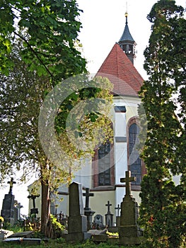 St. Nicholas church and some graves on the cemetery in Benesov