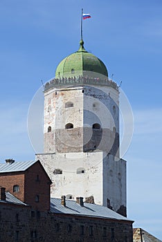 St. Olaf`s tower on blue sky background close-up. Vyborg