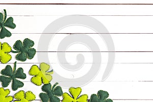 St.Patrick`s day background with felt four-leaf clover on white