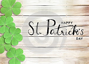 Happy St. Patrick`s Day Black Text Typography Wooden Background with Green Shamrocks clover leaf