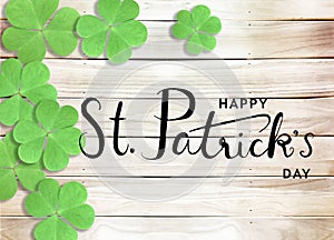 Happy St. Patrick`s Day Black Text Typography Background with Green Shamrocks on Wooden Texture