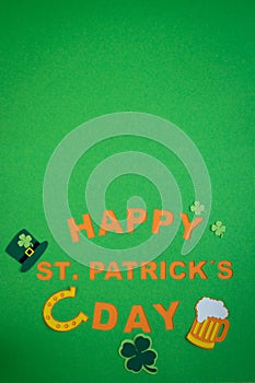 St. Patrick`s Day. Banner design on green background with HAPPY ST. PATRICKS DAY and typical decorations. Copy space. Vertical