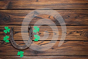 St. Patrick`s Day banner with rusty horseshoe and shamrocks