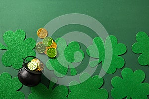 St. Patrick\'s day black pot with coins on green background