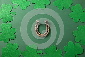 St. Patrick's day border with clover leaves , horseshoe on green.