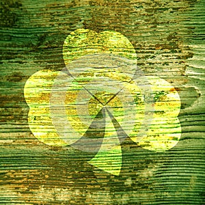 St. Patrick`s Day. Bright spot in the form of a green shamrock clover on a wooden surface