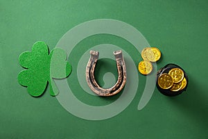St. Patrick\'s day concept with clover leaf, horseshoe, golden coins on green