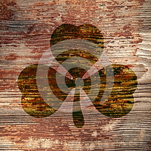 St. Patrick`s Day. Dark stain in the shape of a three-leaf clover on a wooden surface