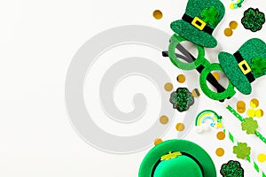 St Patrick`s Day flat lay composition with green party glasses, leprechauns hat, drinking straws, confetti, shamrock clover leave