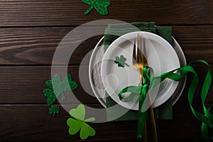 St. Patrick`s Day Green Beer pint over dark green background, decorated with shamrock leaves. Patrick Day pub party, celebrating.