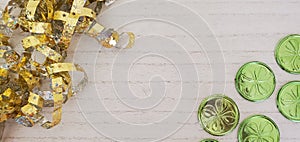 St Patrick's day green coins on white wood background