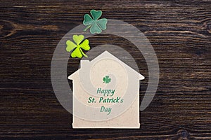 St.Patrick`s day greeting message with home symbol and clover l