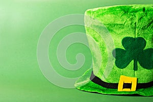 St.Patrick 's Day . hat with clover on green background