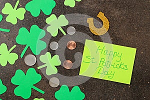 St.Patrick `s Day. Holiday. Frame of green leaves of clover and money on a brown background. view from above