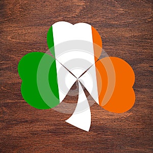 St. Patrick`s Day. Ireland flag color shamrock is drawn on a wooden surface. Three leaf clover