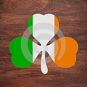 St. Patrick`s Day. Irish flag color shamrock is drawn on a wooden surface. Three leaf clover