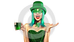 St. Patrick`s Day. Leprechaun model girl with pint of green beer over white background. Patrick Day