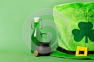 St.Patrick 's Day. shamrock four leaf clover, pot of gold, fedora on green background. St. patrick's day