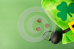 St.Patrick 's Day. shamrock four leaf clover, pot of gold, fedora on green background. St. patrick's day party