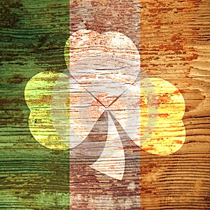 St. Patrick`s Day. Shamrock-shaped light spot on a wooden surface of the color of the Irish flag