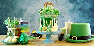 St Patrick`s Day candyland drip cake and party table. photo