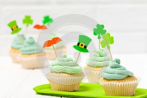 St. Patrick`s Day theme colorful horizontal banner. Cupcakes decorated with green buttercream and craft felt decorations in form