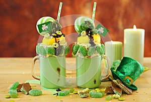 St Patrick`s Day on-trend holiday freak shakes with candy and lollipops.