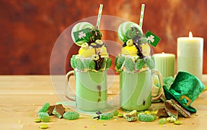 St Patrick`s Day on-trend holiday freak shakes with candy and lollipops.