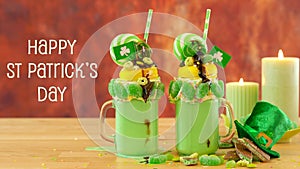 St Patrick`s Day on-trend holiday freak shakes with candy and lollipops.