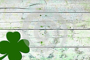 St Patricks day background. Shamrocks over a light green wood background