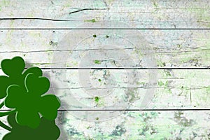 St Patricks day background. Shamrocks over a light green wood background