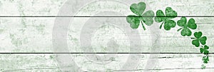 St Patricks day background. Shamrocks over a light green wood background. Decoration for St. Patrick\'s Day