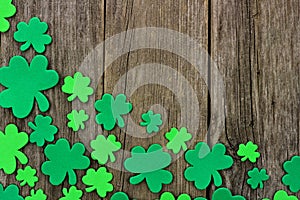 St Patricks Day corner border of shamrocks over rustic wood