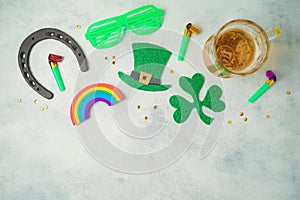 St Patricks day holiday concept with lucky charms, shamrock and beer glass on rustic background. Top view from above