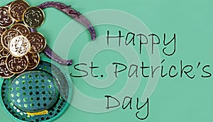 St Patricks day Irish good luck items plus gold on a green paper background with copy space plus text