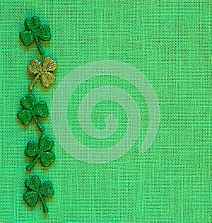 St. Patricks Day or Irish Green Shamrocks on Burlap Linen Background with copy space.  It`s square with a trendy flat layout