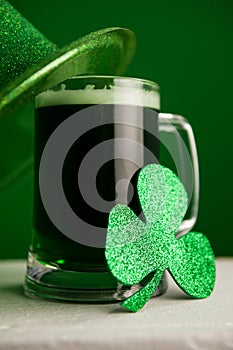 St Patricks Day leprechaun hat with mug of green beer and shamrock