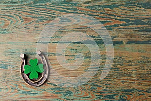 St. Patricks day, lucky charms. Horesechoe and shamrock on wooden background