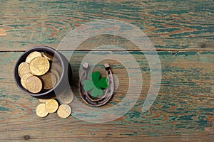 St. Patricks day, lucky charms. Horesechoe and shamrock on wooden background