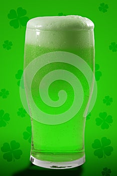 St Patricks day party and Irish celebration of patron saint concept theme with a pint of frothy beer with froth spilling over