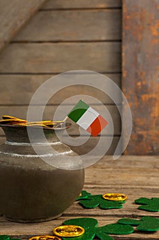 St. Patricks Day pot of chocolate gold coins with irish flag and shamrocks