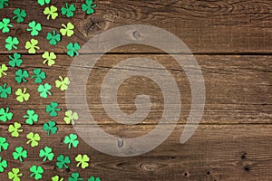 St Patricks Day shamrocks side border over rustic wood