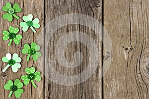 St Patricks Day side border of shamrocks over rustic wood